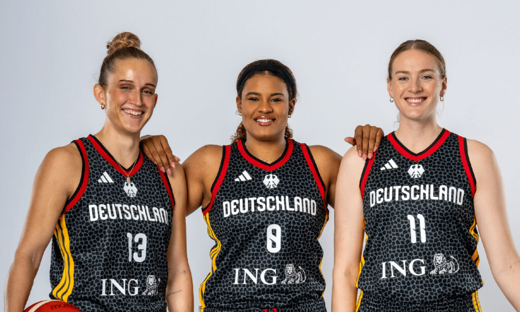 Basketball-Frauen in adidas-Trikots